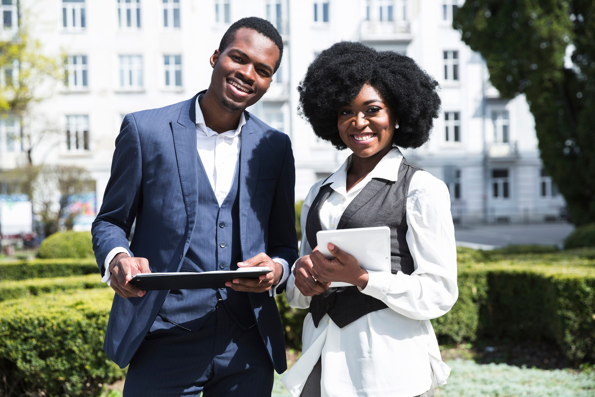 https://atriumhomes.ng/wp-content/uploads/2024/02/portrait-african-young-businessman-businesswoman-holding-clipboard-digital-tablet-looking-camera1.jpg